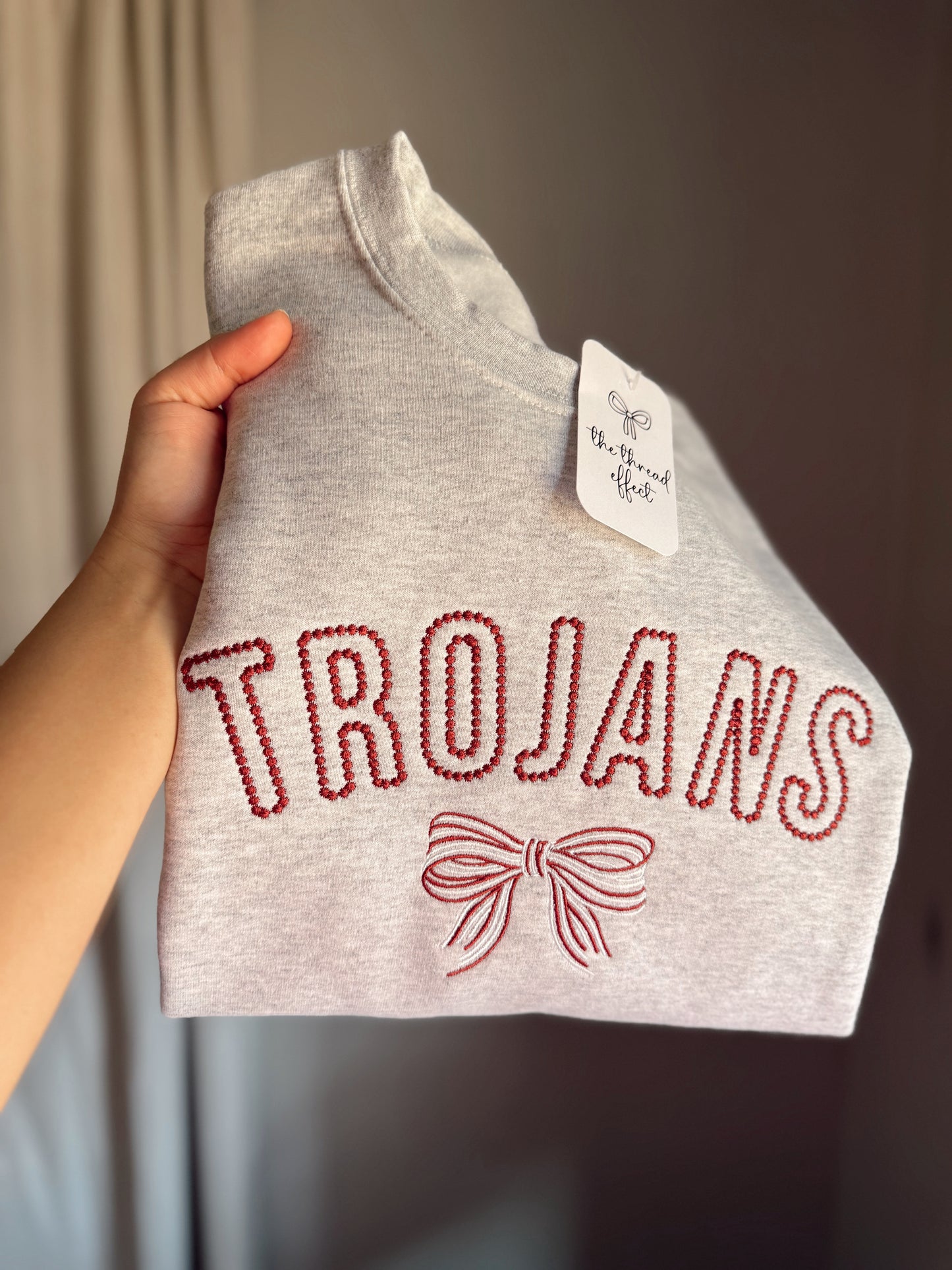 Embroidered mascot with bow